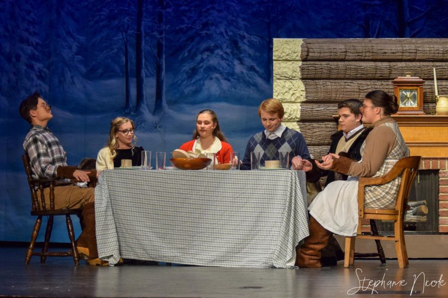 Junior Harry Pala, senior Emma Loomis, juniors Jackie Bobos and Tyler Smith, sophomore Kyle Rassel, and freshman Genesis Sandoval sit during a scene at the Beaver house. 