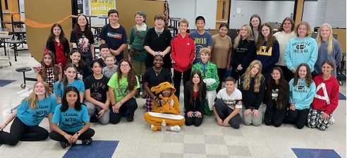 Halloween Gathering: NJHS members take a group photo after the Halloween Social, just before they commence the restoring of the cafeteria.