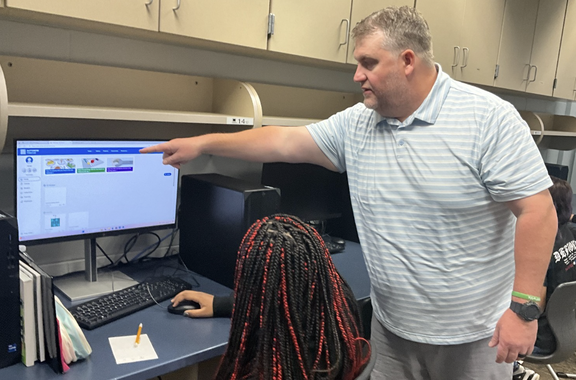 Leading the Way: Mr. Jennings aids one of his students in getting to the right program. Regarding what he anticipated for the year, he said, “One of the best things about being a teacher is seeing the growth and successes of your students, and that’s what I’m looking forward to.” 