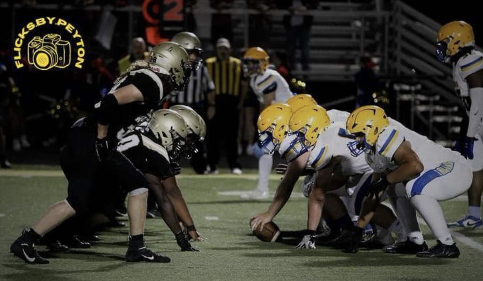 The Rivalry Resumes: The Panthers and the Trojans are poised on the line of scrimmage, Highland in possession. 