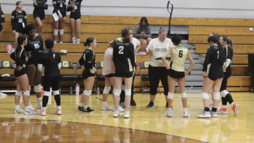 The volleyball team takes a timeout to discuss their game plan going into the second set. 