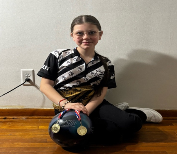 Jennifer Turner poses with her gold medals and her bowling ball.