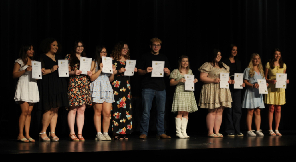 Students accepting the Best Thespian award at the annual awards night ceremony in the GHS auditorium.