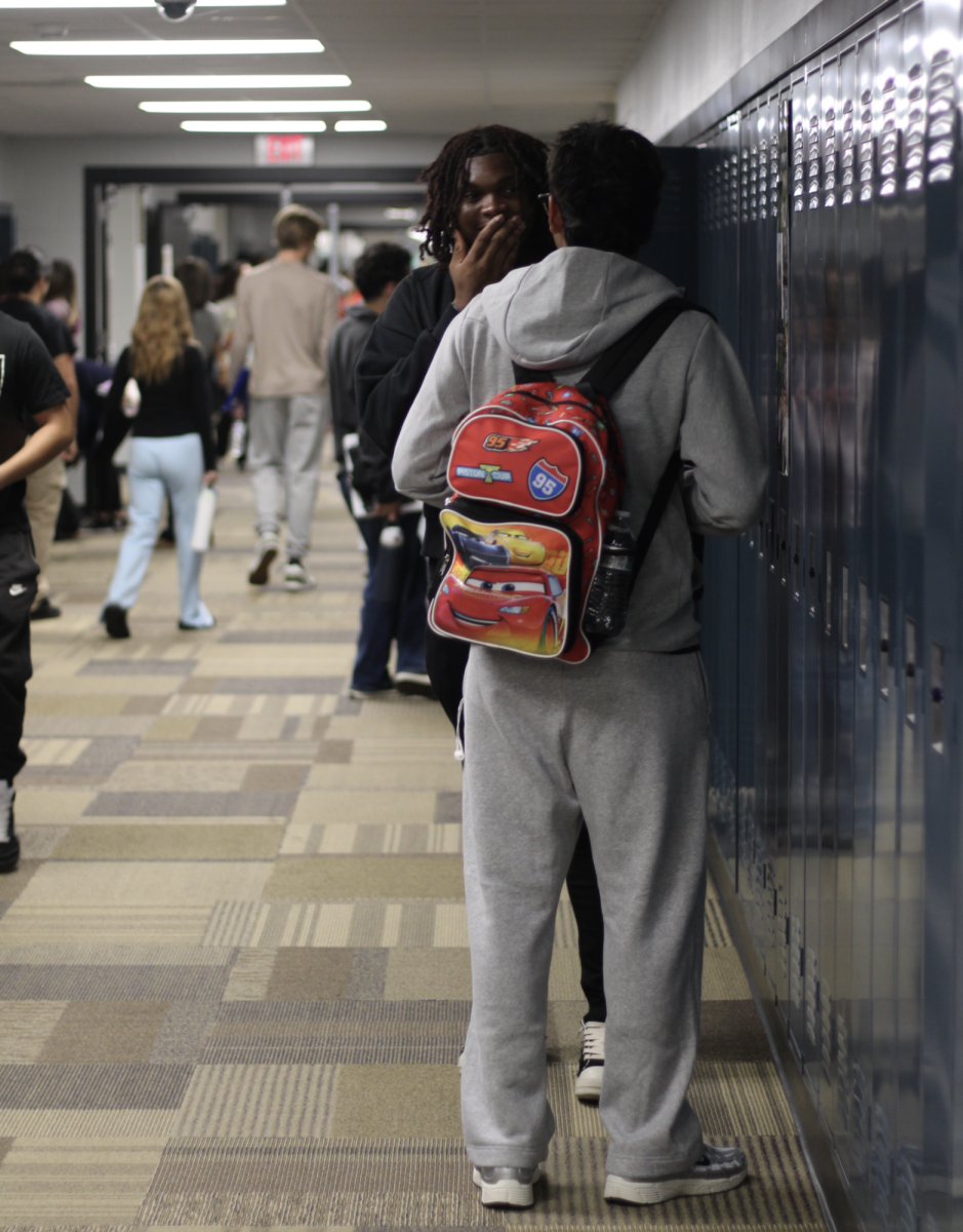 Seniors Jayden Serrano and Clarence Wright giggling before classes begin.