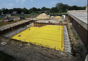 First stage of the aquatic center construction shows the gold, eight-lane pool nearing completion. 