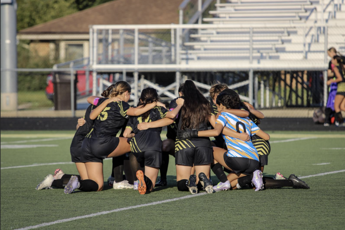 The Griffith Girls Soccer Team huddles up before the game to talk strategy.