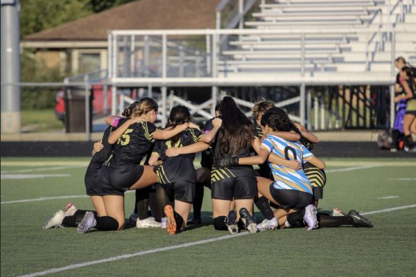 The Griffith Girls Soccer Team huddles up before the game to talk strategy.
