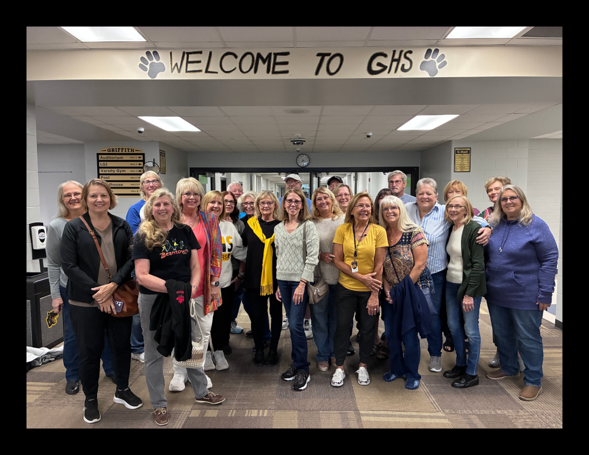 Members of the class of 1975 pose for a group photo before a planned school tour that featured performances by the band, choir and theater departments ahead of the Panther Pride Night game.