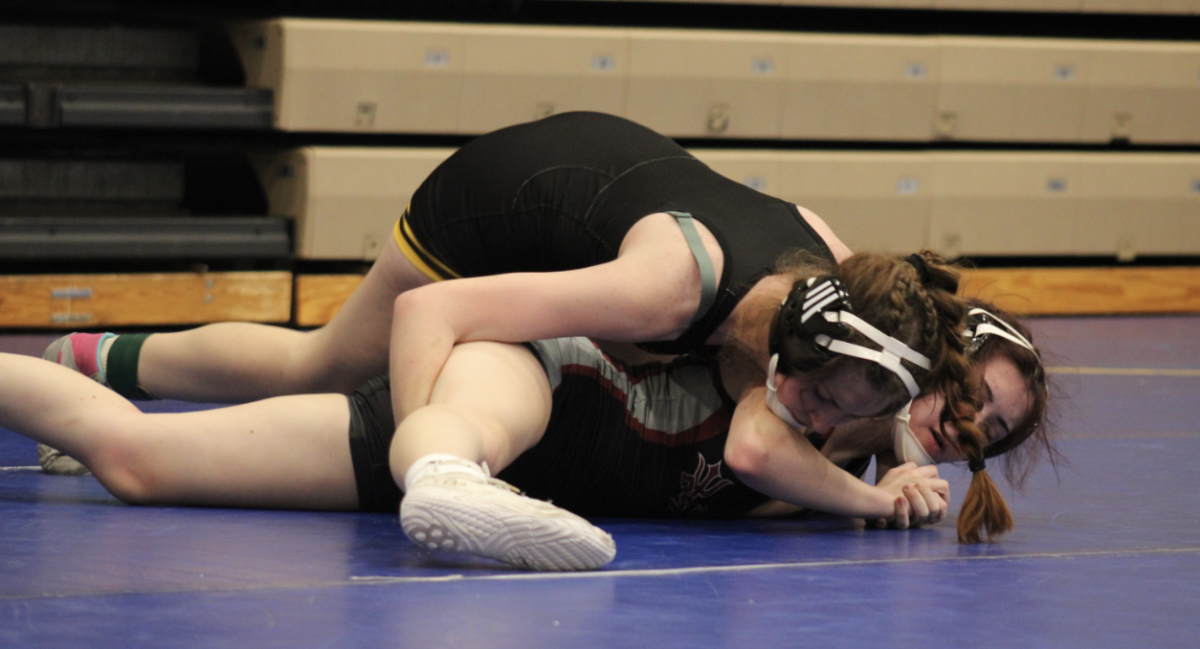 Sophomore Lexi Scott attempts to pin Lowell opponent at Lowell High School. Scott, however, did not win this match but she is determined to win the next.