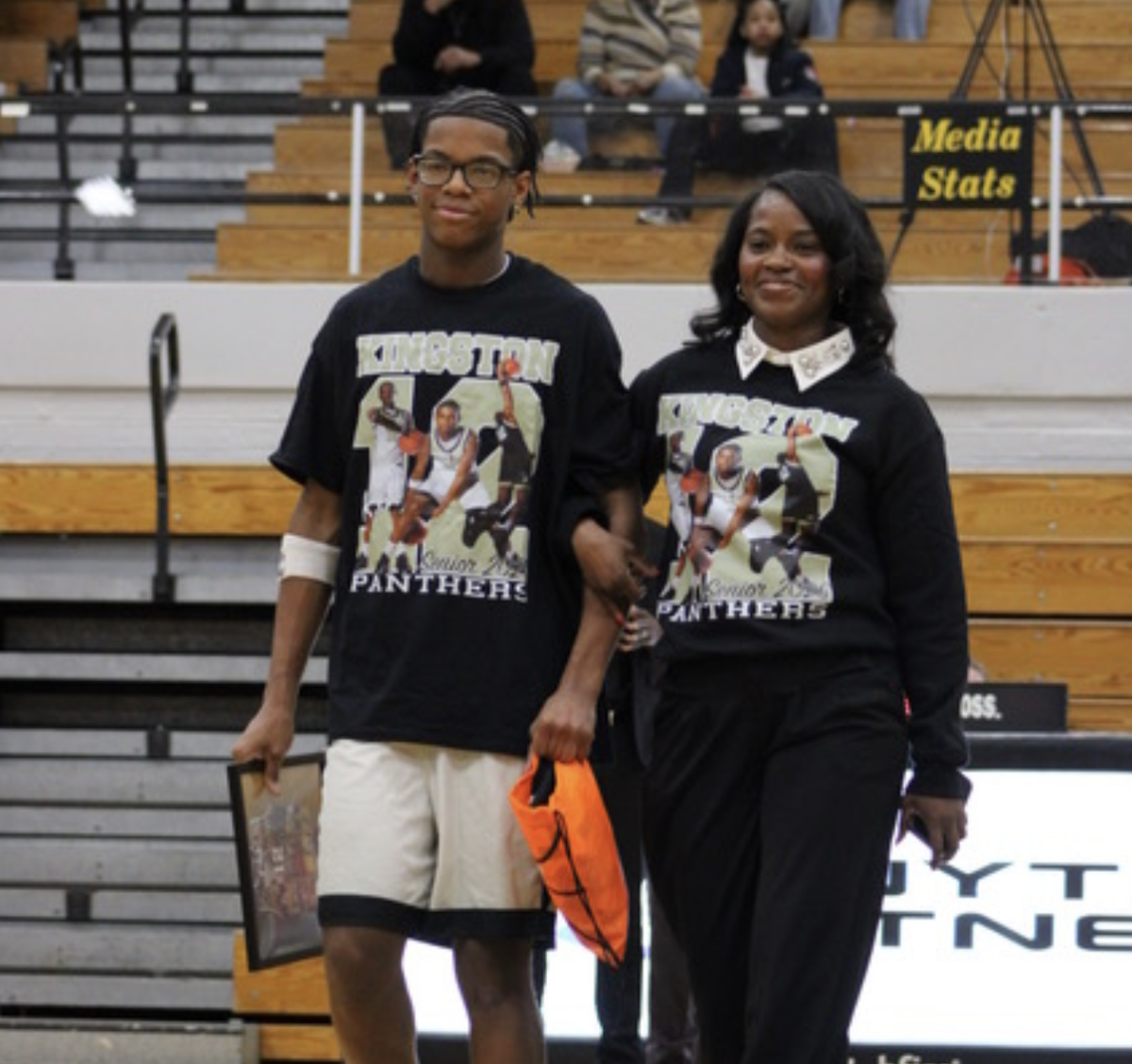 Senior Kingston Gant escorted by his mother on Boys Basketball Senior Night. Gant was starting guard for Griffith.