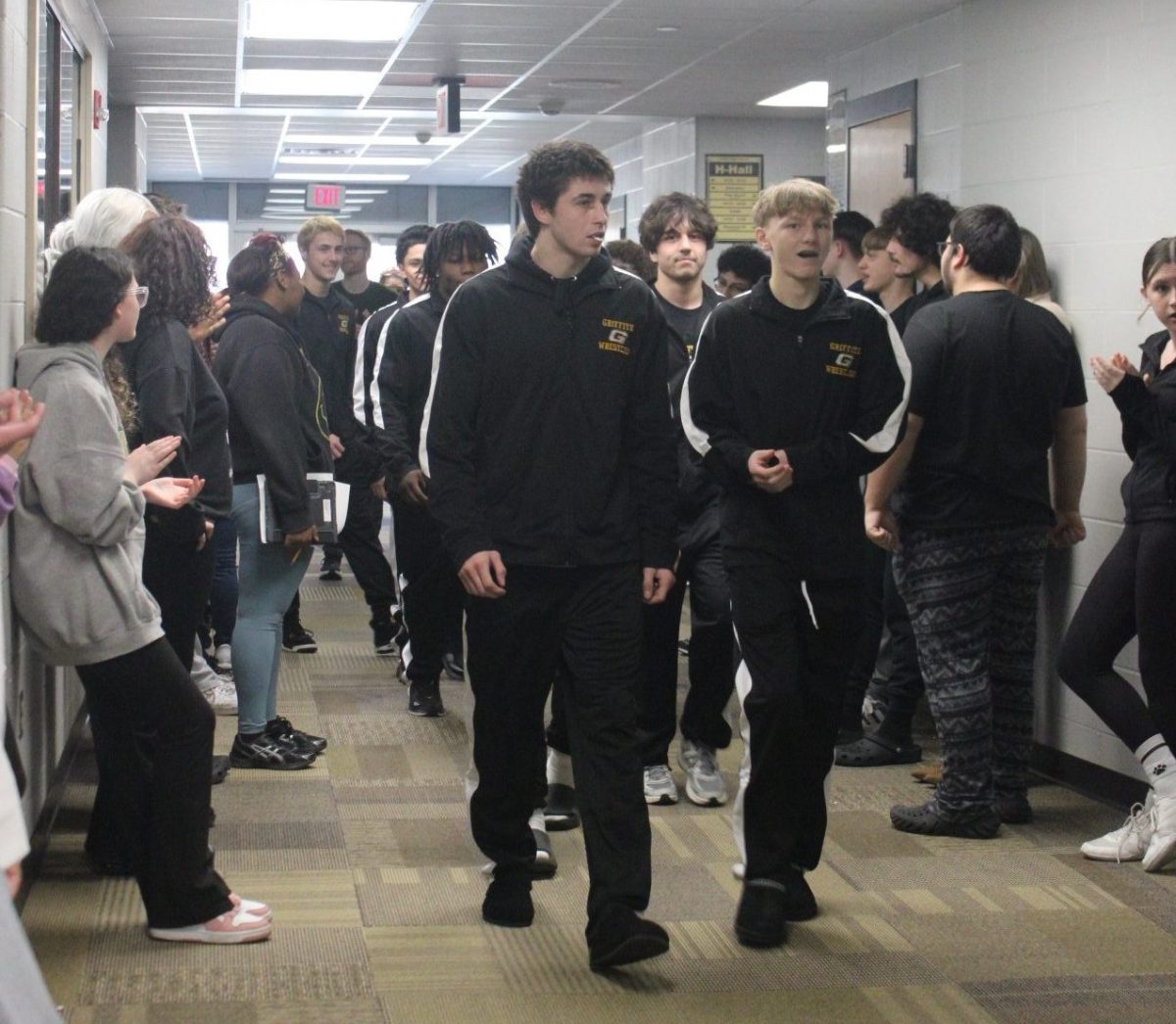 Senior Zach Kenney and his wrestling teammates walk in the “G” hallway for send off to IHSSA State Competition. All high school classes lined the hallway to watch and show their support for him and the team.
