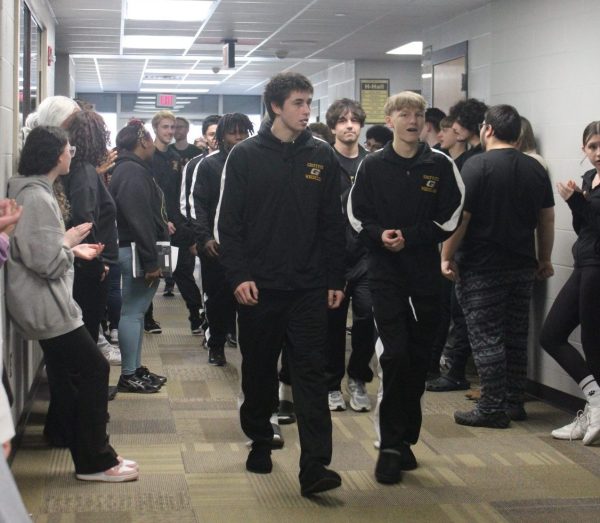 Senior Zach Kenney and his wrestling teammates walk in the “G” hallway for send off to IHSSA State Competition. All high school classes lined the hallway to watch and show their support for him and the team.
