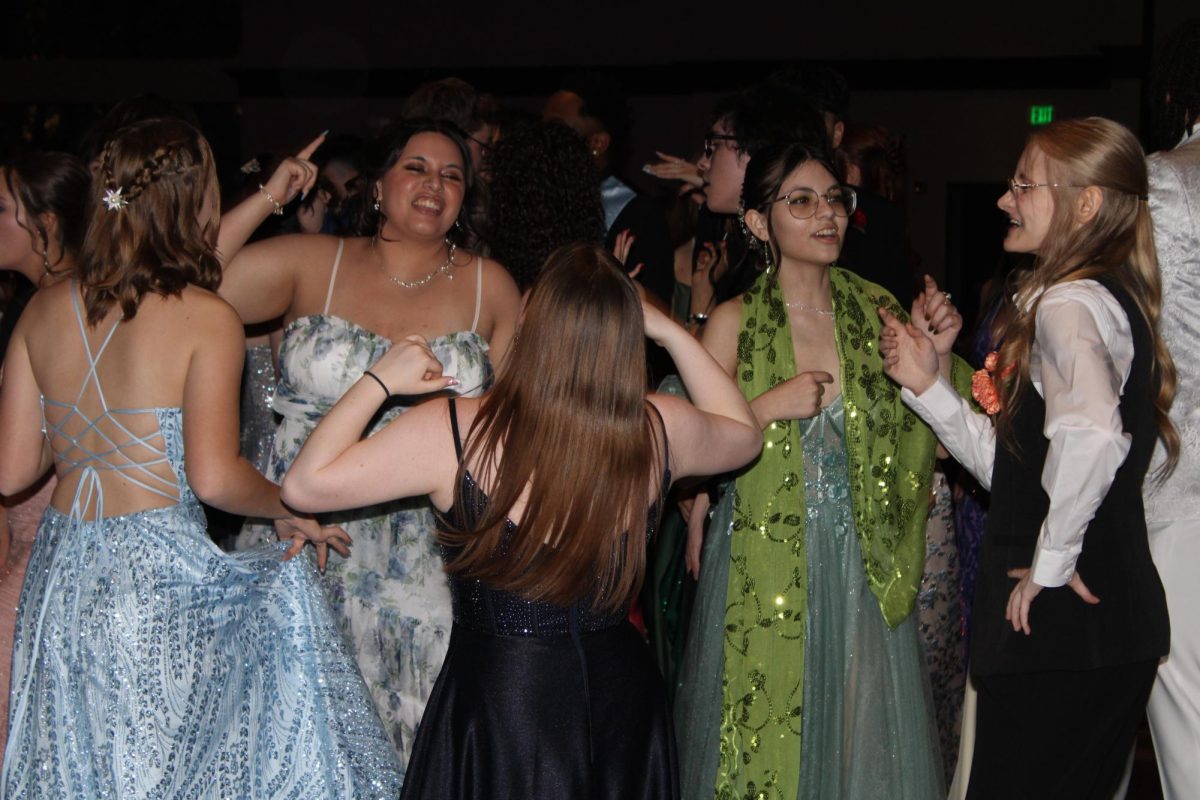 Celeste Bernhardt, Aubrianna Duch, and Noralena Grubish dance at prom, having a blast. It shows how even during the busy school year students find time to have fun.
