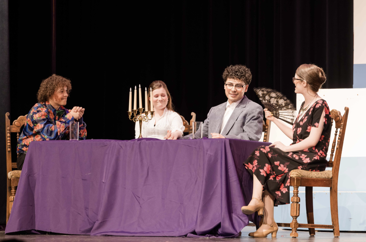 Nicholas Grahovac (Sr) sits at a table with Mya Munsie (Jr), Jeremiah Fuentes (Sr), and Kennedy Reitz (Jr). In this scene, Fuentes, who plays Frank Abagnale Jr. is having dinner with Brenda Strong (Munsie) and her parents (Grahovac and Reitz).