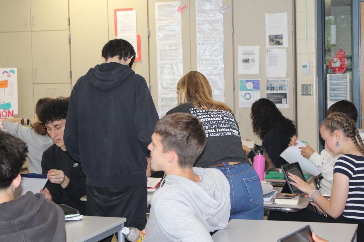 Mrs Chavez-Reda works with a student from the entrepreneurship course about an assignment. Chavez-reda will take an in-coming class next year for the new pathway.